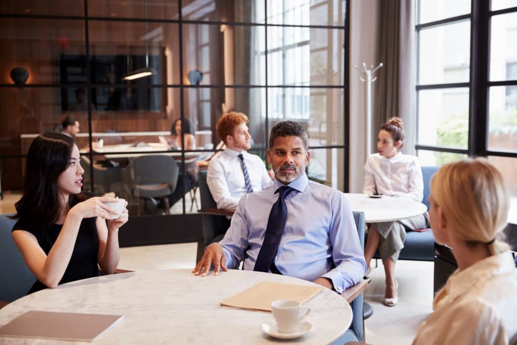 team having a meeting over coffee