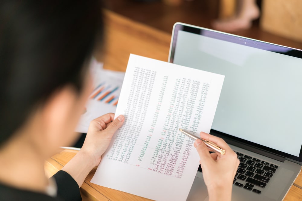 businesswoman reviewing invoices for timely payments managing accounts receivable