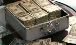 a close picture of a container full of bundle dollar bills