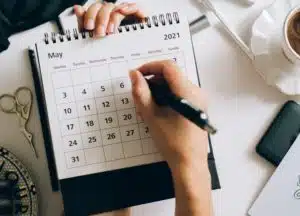 a close-up picture of a girl doing a calendar record keeping