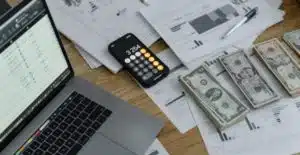 (a picture of a table with a laptop and calculator aside from it is cash for payroll