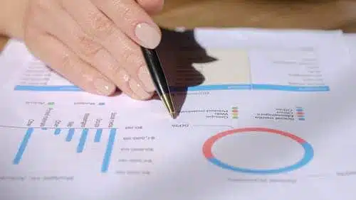 hand with a pen pointing on accounting report