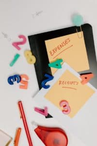 expenses and receipts text on sticky notes with number magnets