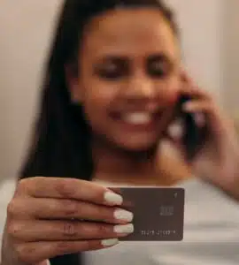 picture of woman using a credit card with a smile on his face